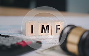 A photograph with the word imf on a wooden block. photo