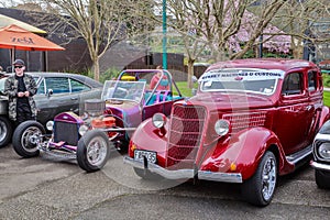 A 1935 Ford Coupe car next to a customized hot rod