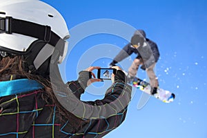 Photographed snowboarder jump with cell phone