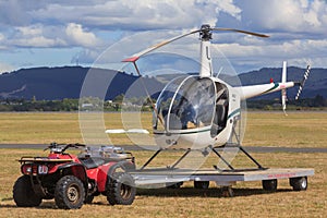 A Robinson R22 light utility trailer being towed on a trailer