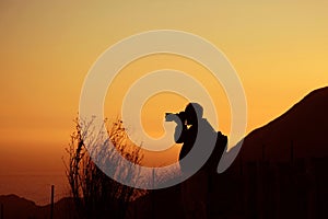 Photographer at sunset