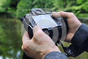 A photographer adjusts the camera