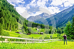 Photographer and alpine landscape in Alps, Austria