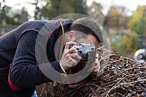 Photographer with analogue film camera outdoors