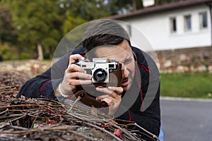 Photographer with analogue film camera outdoors
