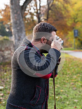 Photographer with analogue film camera outdoors