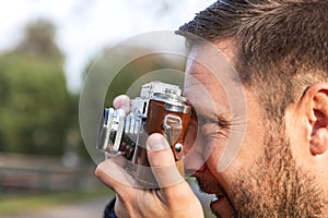 Photographer with analogue film camera outdoors