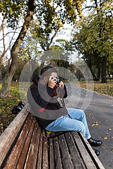 Photographer with analogue film camera outdoors