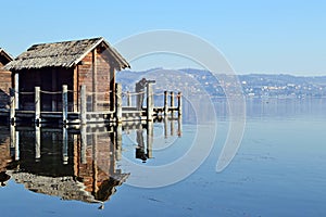 Photographer on ancient lake dwellings in Viverone Lake, Piedmont. Italy