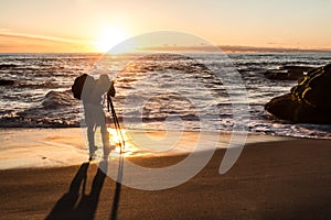 Photographer at Beach Taking Pictures in Silhouette