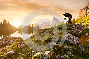 A photographer in the beautiful lake Federa