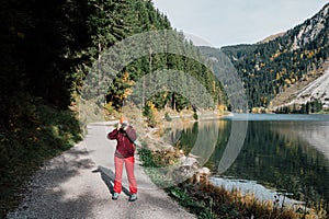 photographer with a camera, a mountain lake, walking in nature