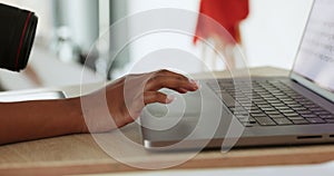 Photographer with a camera and on their laptop in the studio to check the pictures. Woman looking at design or photos on