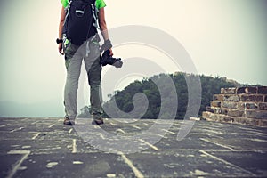 Photographer with camera on top of great wall