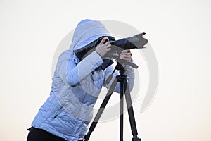 photographer with camera and tripod outdoor taking landscape picture