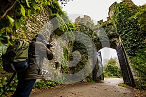 photographer capturing ivycovered castle gate