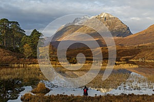 Photographer capturing the morning light at Loch Clair, Scotland