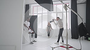 photographer is capturing professional football player with ball in studio, content for magazine