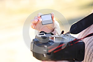 Photographer changing card on dslr camera