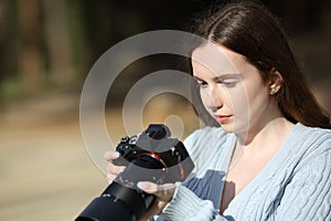 Photographer checking pictures on mirrorless camera