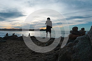 Photographer on Cliff and Beautiful Sunset