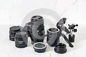 Photographer equipment: lenses, tripods, adapters, macro rings, macro rails on a white background.
