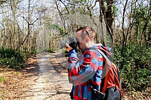 Photographer in the forest photographing the natural environment