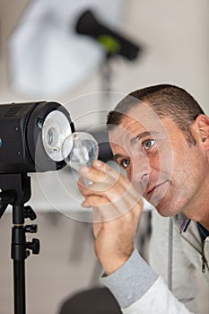 photographer in front studio lamp with flashlight