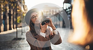 Photographer in glasses with retro camera take photo girlfriend. Tourist smile girl in hat travels in Barcelona holiday