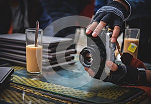 Photographer hand is holding the vintage camera to taking photo