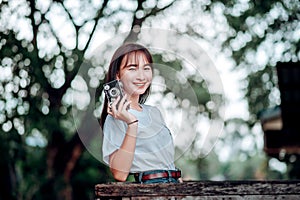 photographer. Happy holiday woman taking photos with Fleme camera and smiling