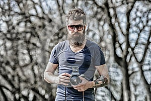 Photographer hold vintage camera. Modern blogger. Content creator. Man bearded hipster photographer. Photographer with