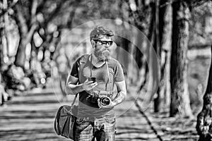 Photographer hold vintage camera. Modern blogger. Manual settings. Photographer with beard and mustache. Tourist