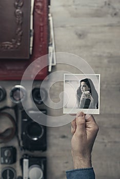 Photographer holding an instant photo