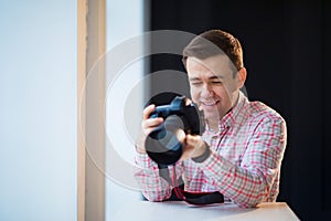 Photographer holds a camera. creative profession