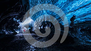 Photographer inside a blue ice cave