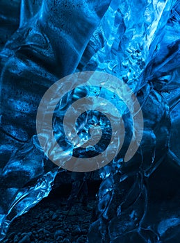 Photographer inside a blue ice cave