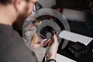 Photographer inspecting a medium format camera on desk