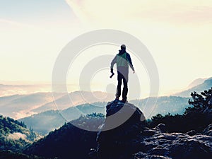 Photographer looks into the landscape and listen the silence. Man prepare camera to takes photos