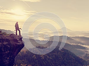 Photographer looks into the landscape and listen the silence. Man prepare camera to takes photos