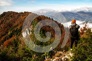 Photographer making photos in autumn mountains