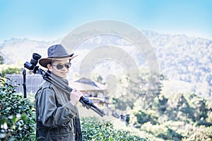 Photographer man in green tea field nature