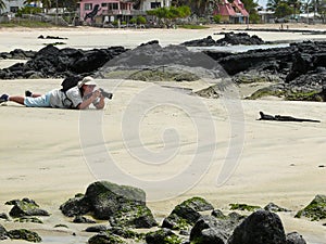 A photographer and a marine iguana