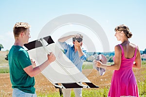 Photographer, model, and assistant on set during a photo shoot