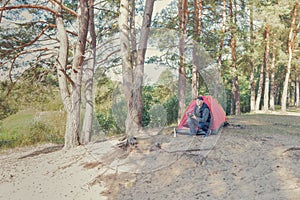 Photographer in nature photographs the landscape of the forest