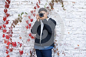 Photographer near white wall background