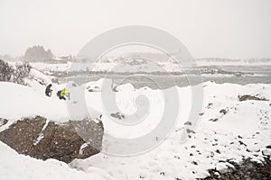 Photographer in Norway winter storm landscape with heavy snow ,polar circle whether