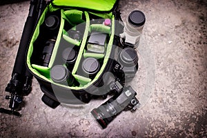 Photographer pack his camera and lenses to bagpack. photo
