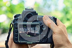 A photographer is photographing the bridge. He is holding the camera