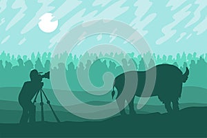 Photographer photographs walking bizon on field